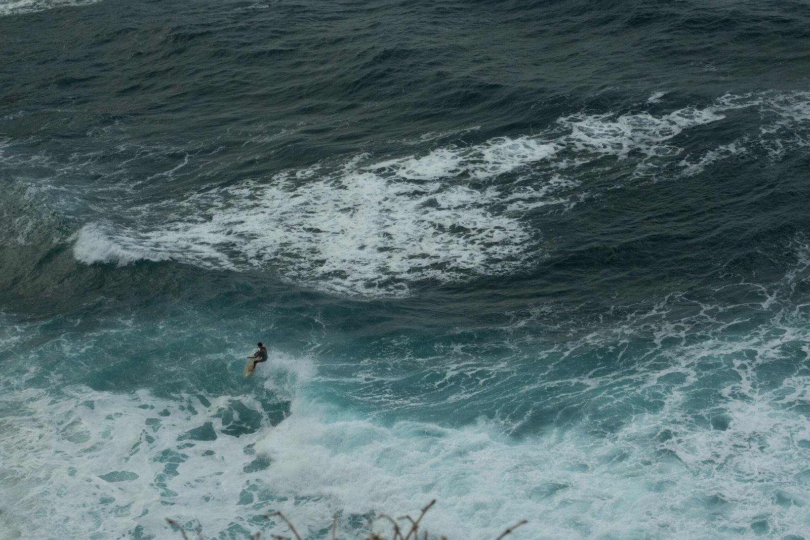 a person riding a wave on top of a surfboard